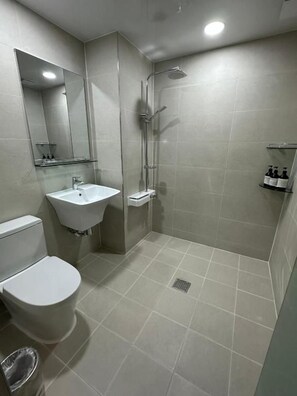 A bathroom with a toilet, sink, shower, and mirror. - Pyeongchon COA (Anyang)