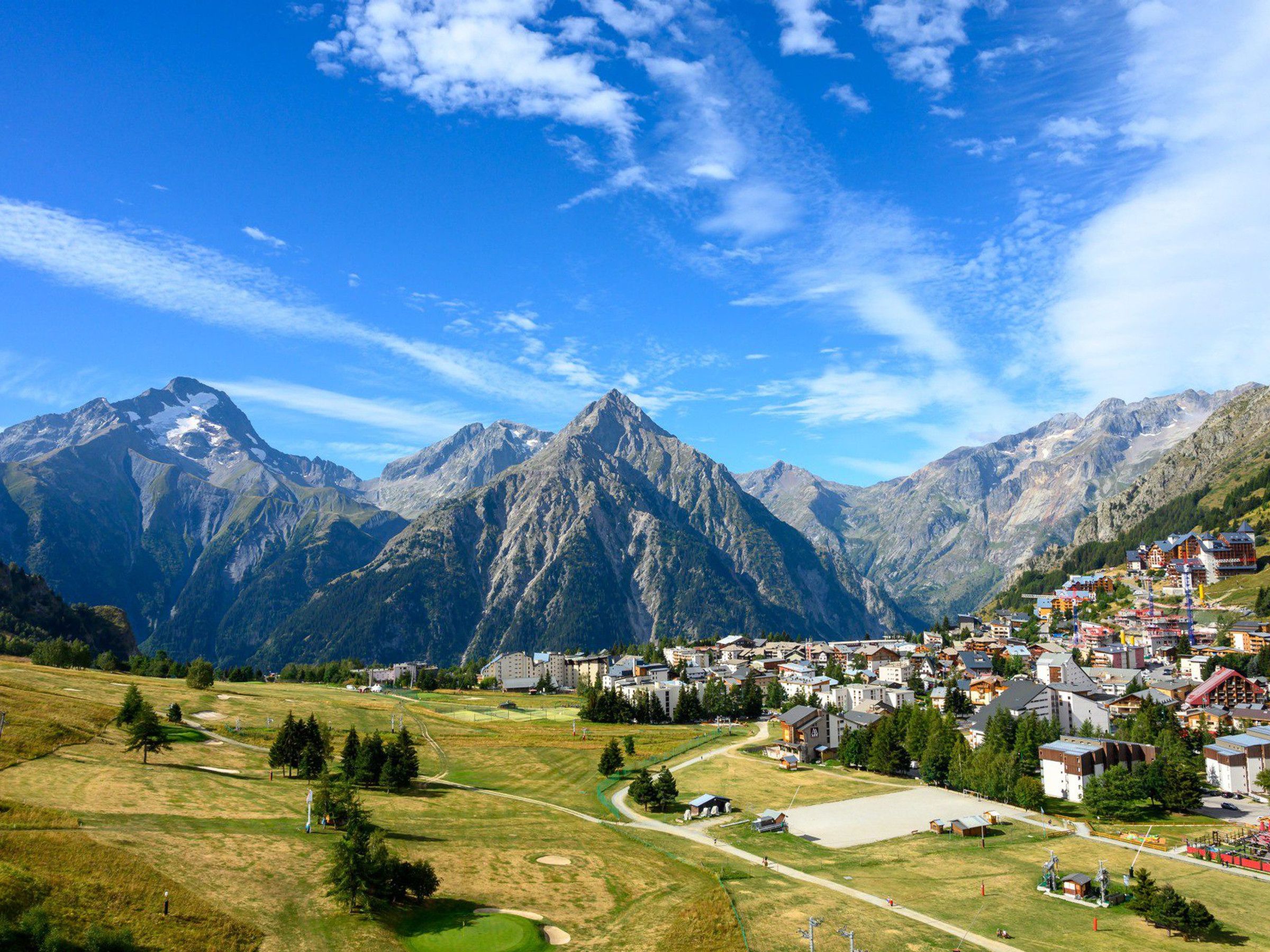 A mountainous landscape with a town nestled in the valley.