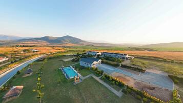 A large property with multiple buildings, a swimming pool, and a well-maintained lawn.