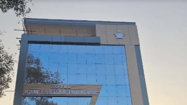 A modern building with a reflective glass facade and a sign that reads 'Hotel'. - HOTEL SHREE KARNI PALACE (Sultanpur)