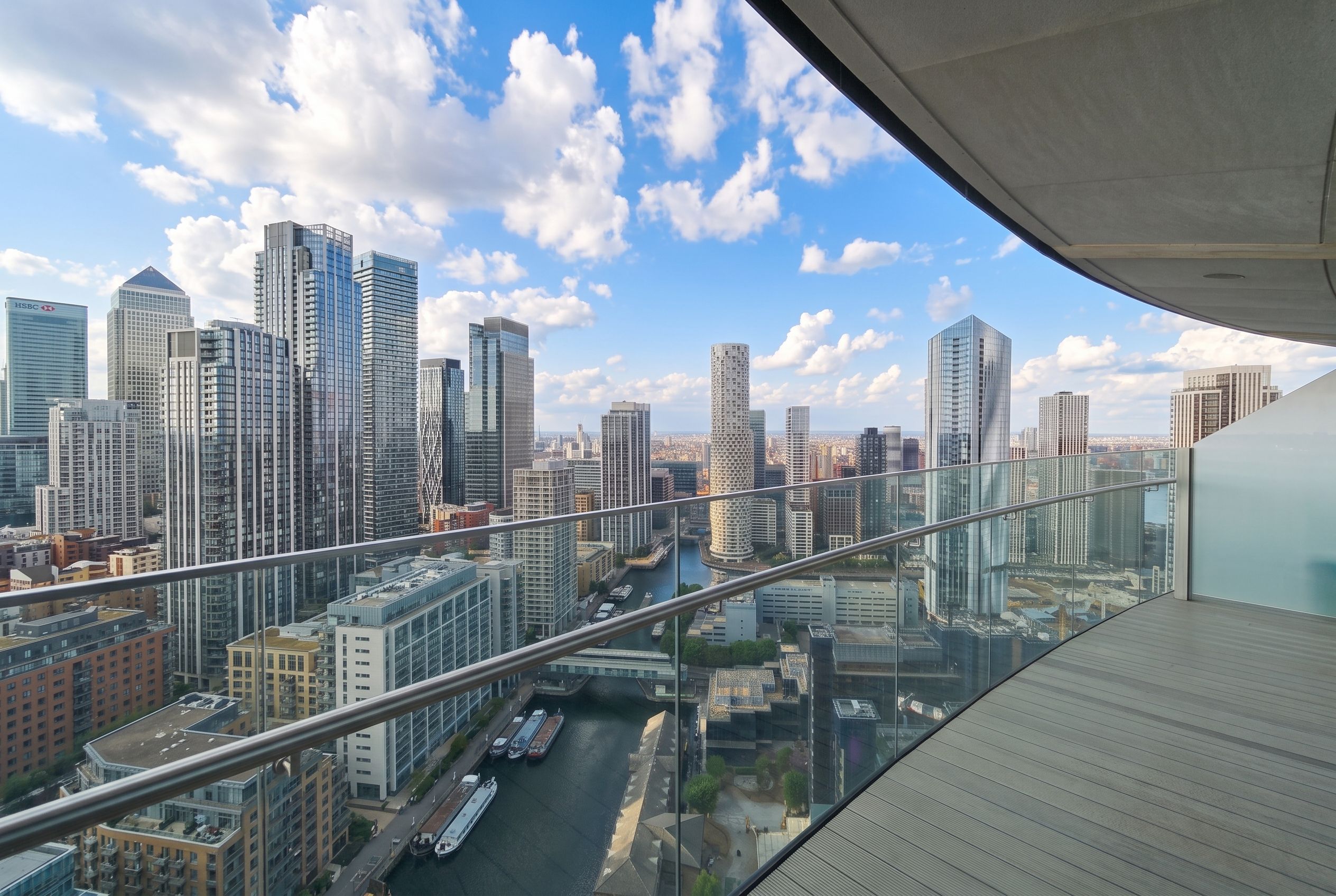A high-rise building with a view of a city skyline, including several skyscrapers and a river.