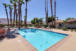 A swimming pool with lounge chairs and palm trees. - Sunrise Country Club Condo w/ Pool & Tennis (Rancho Mirage)