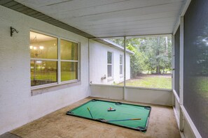 A room with a pool table, windows, and a view of the outdoors. - Near World Equestrian Ctr: Ocala Home w/ Yard (Ocala)