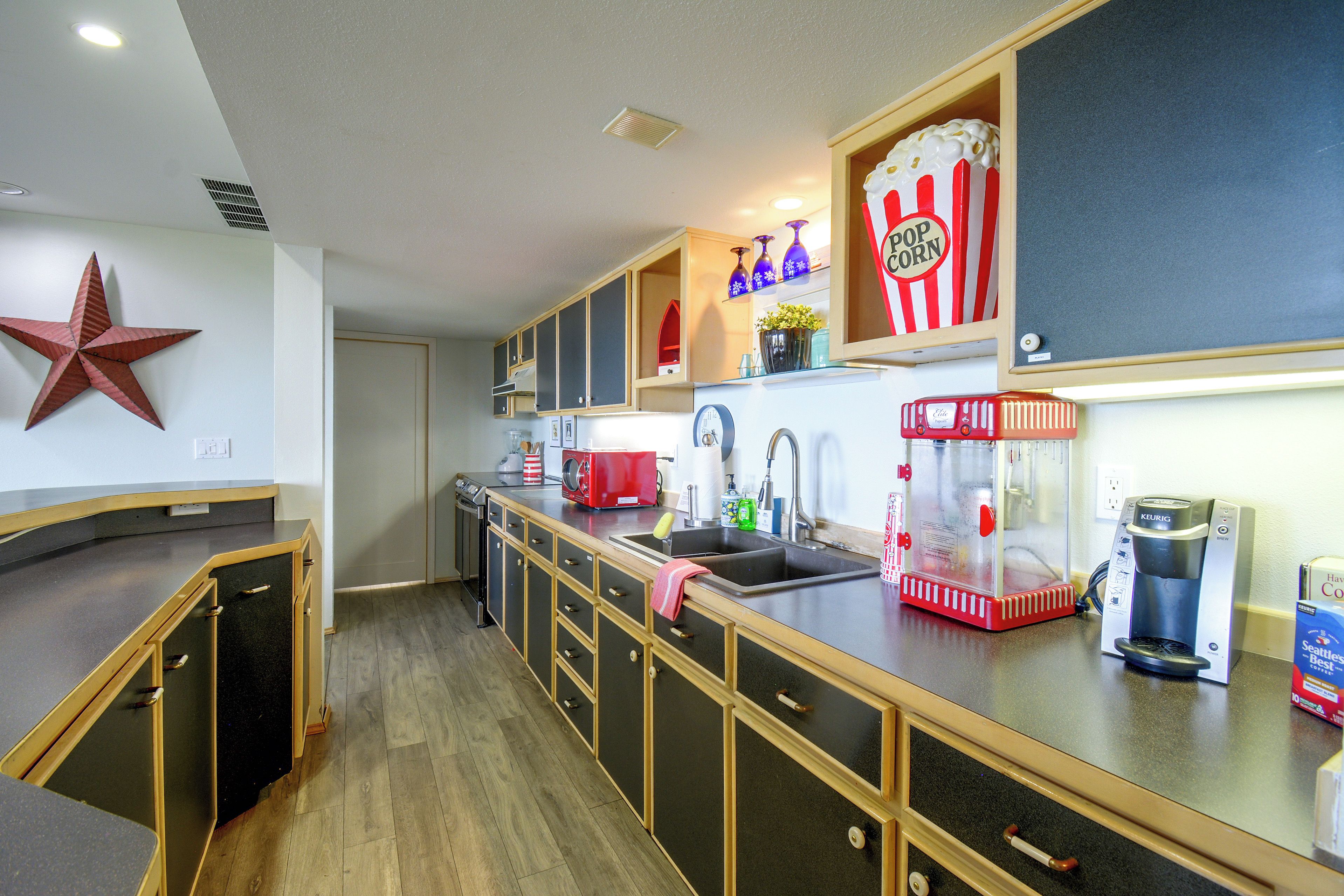 A kitchen with wooden cabinets, a star decoration, a popcorn machine, and a coffee maker.
