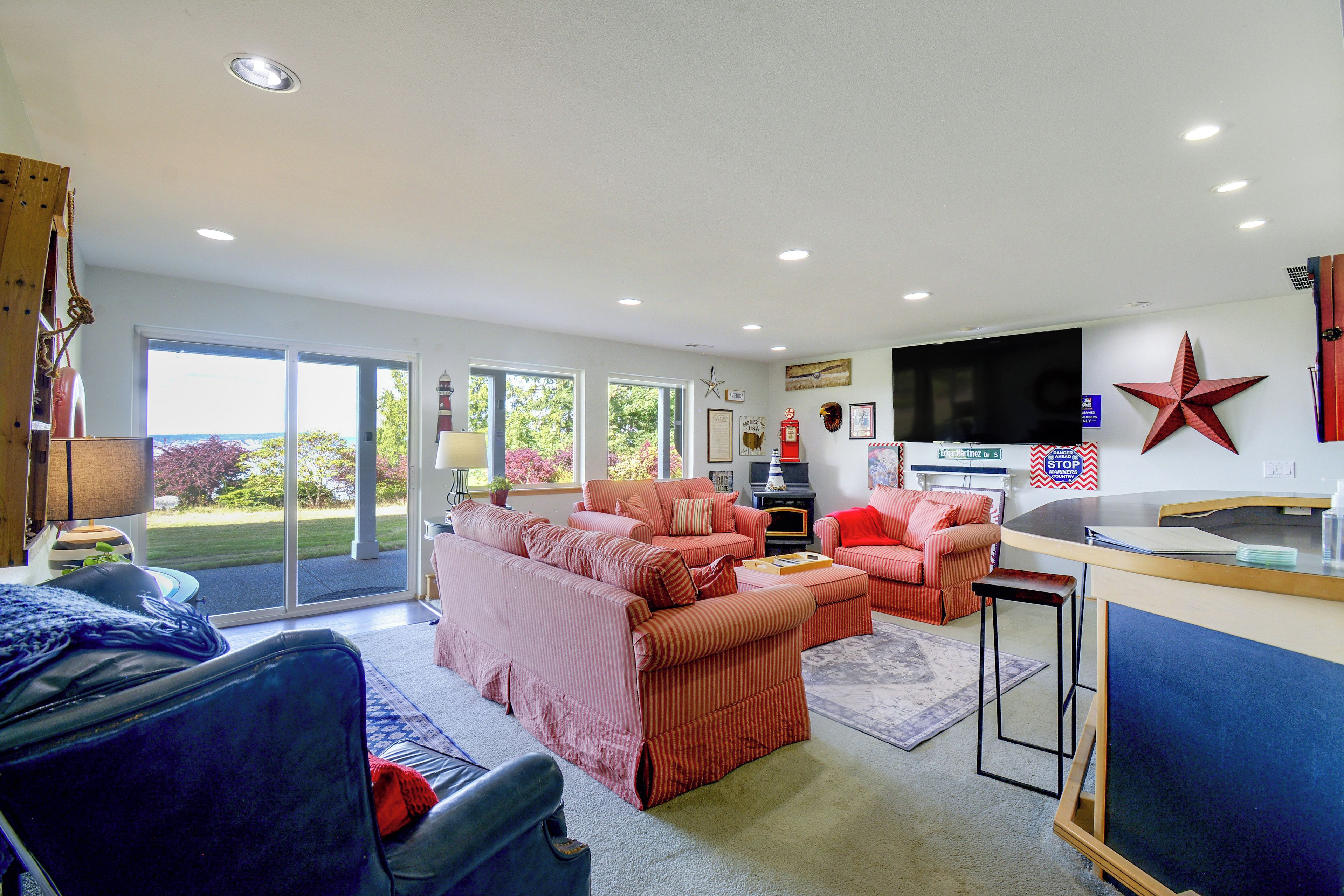 A living room with a large flat-screen TV, a star decoration, and a fireplace.