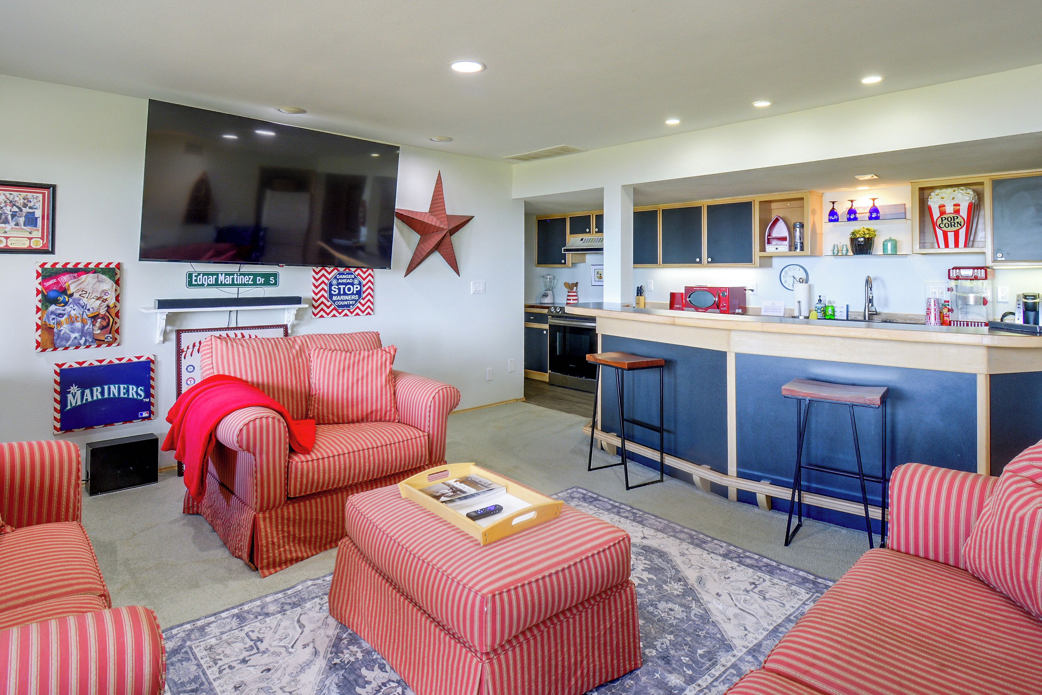 A living room with a red-striped sofa, a coffee table, and a television.