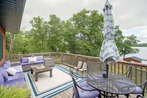 A deck with outdoor furniture, including a sofa, chairs, and a table. - Sibley Shores Lake Cabin w/ Dock & Deck! (Pequot Lakes)
