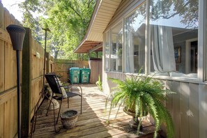 A wooden deck with a covered seating area, a potted plant, and a view of the house. - Walk to Gulfport Beach! Coastal Studio Getaway (Gulfport)