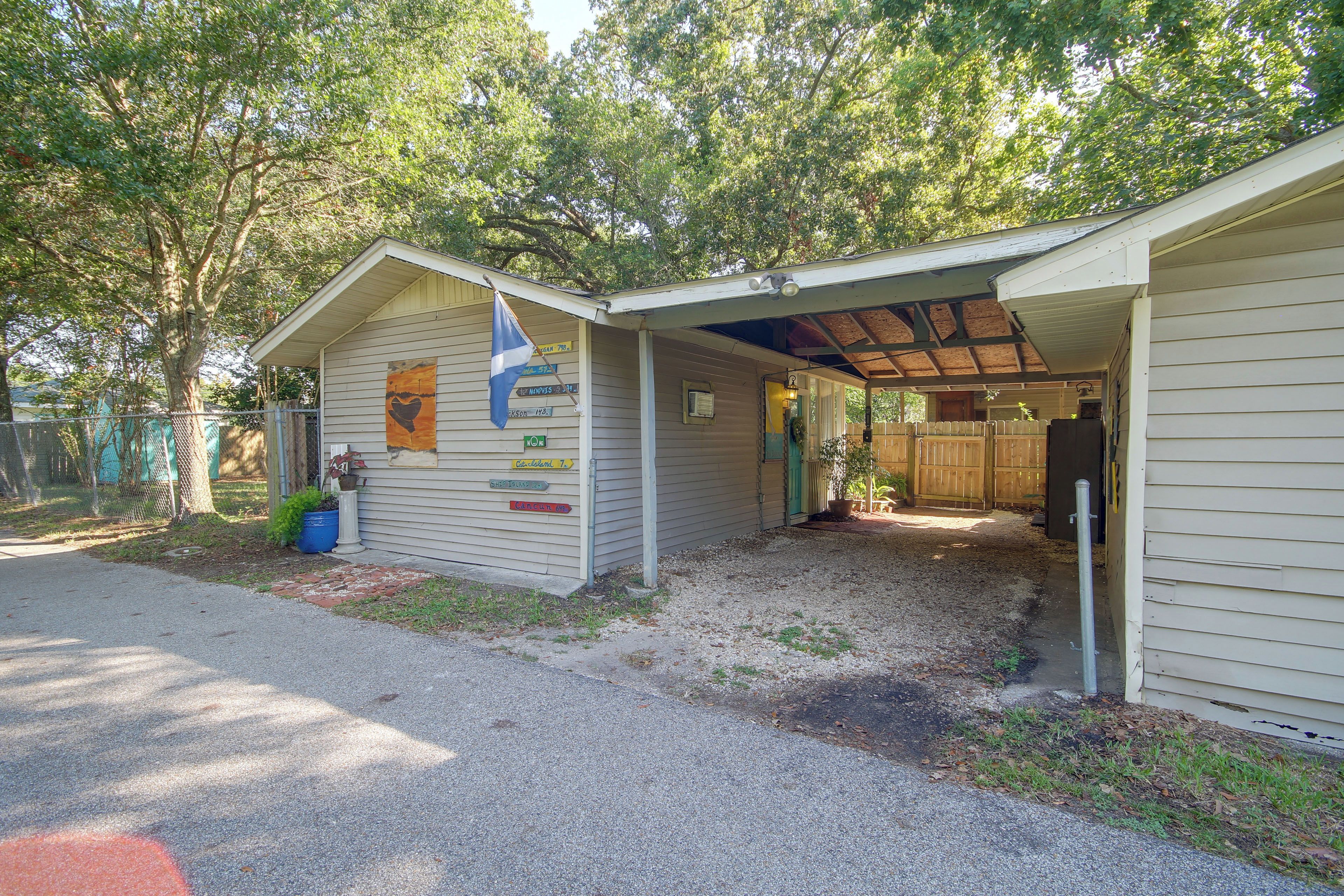 A small, single-story building with a covered porch and a flagpole.