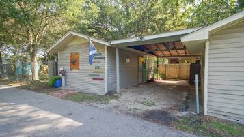 A small, single-story building with a covered porch and a flagpole.