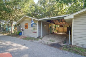 A small, single-story building with a covered porch and a flagpole.