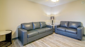 A room with two sofas, a small table, a lamp, and a ceiling fan. - See the Royal Gorge! Cañon City Apartment (Canon City)