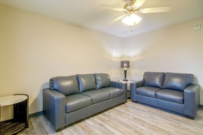 A room with two sofas, a small table, a lamp, and a ceiling fan. - See the Royal Gorge! Cañon City Apartment (Canon City)