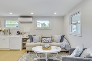 A modern kitchen with white cabinetry, a built-in dishwasher, and a window above the sink. - Sun, Surf & Seafood: York Home 2 Blocks to Beach (York Beach)