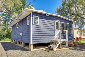 A small, single-story house with a blue exterior, a front porch, and a small garden area. - Sun, Surf & Seafood: York Home 2 Blocks to Beach (York Beach)