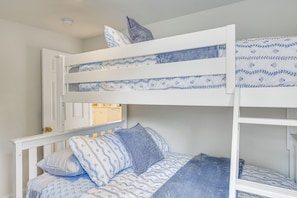 A bunk bed with a white frame and blue bedding. - Sun, Surf & Seafood: York Home 2 Blocks to Beach (York Beach)