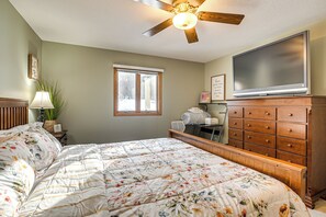 A bedroom with a bed, dresser, television, window, and ceiling fan. - Game Room, Screened Porch! Howard A-frame Chalet (Howard)
