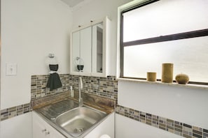 A bathroom with a sink, mirror, and window. - 6 Mi to Beach! Sarasota Studio w/ Screened Porch (Sarasota)