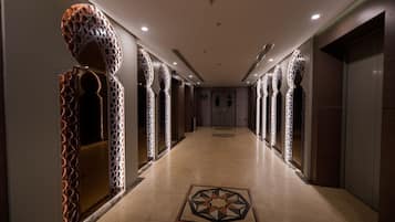 A hallway with patterned walls and a geometric floor design.