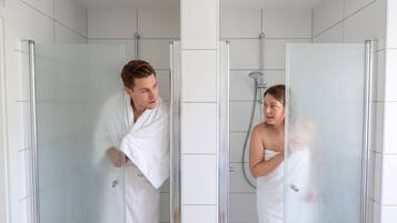 Shower, hair dryer, soap, toilet paper