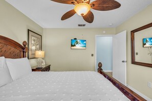 A bedroom with a bed, a ceiling fan, a nightstand, a lamp, and a framed picture on the wall. - On the Intracoastal | Pool | Fishing Pier | Walk to Beach | Indian Sands B3 (Indian Shores)