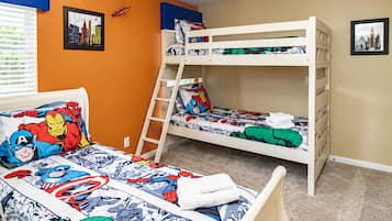 Quarto com beliche decorado com tema de super-heróis, escada e duas molduras nas paredes.