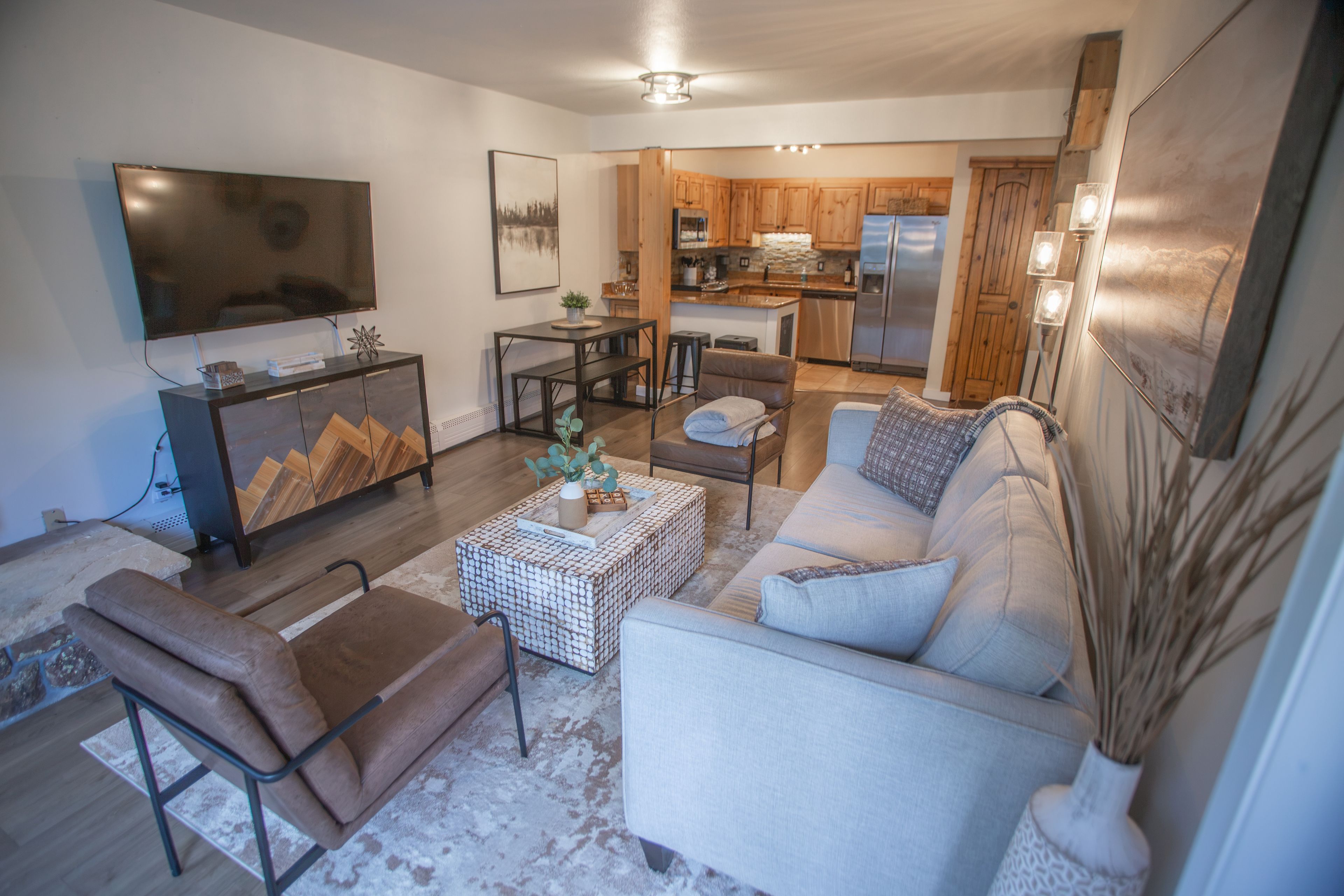 A modern living room with a sofa, a coffee table, and a TV.