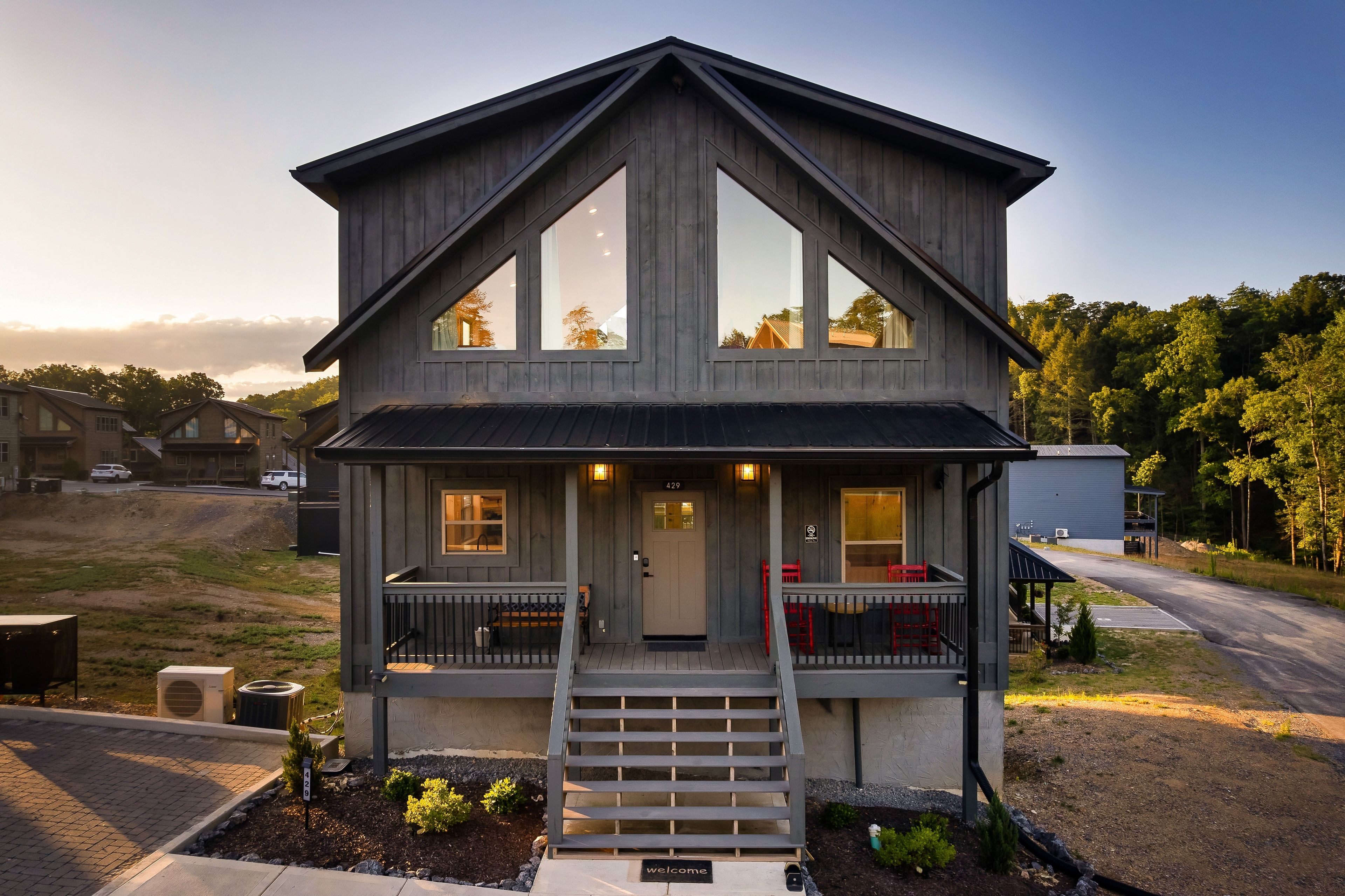 A two-story house with a front porch, large windows, and a number '429' sign.