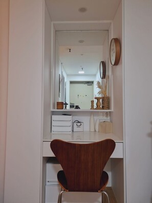A modern bathroom with a vanity, mirror, and a clock on the wall. - Gimpo Airport 3 min · Seoul Station 25 min · Hongdae 20 min · Gangnam 35 min (Seoul)