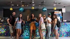 A group of people standing in a modern interior with a colorful, patterned wall and pendant lighting. - Be-city Hotel Eilat (Eilat)