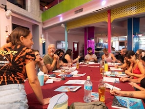 A group of people seated at a table with art supplies, engaged in a painting activity. - Be-city Hotel Eilat (Eilat)