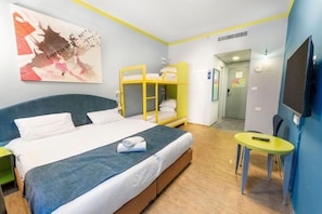 A hotel room with a single bed, a bunk bed, a small table, and a TV. - Be-city Hotel Eilat (Eilat)