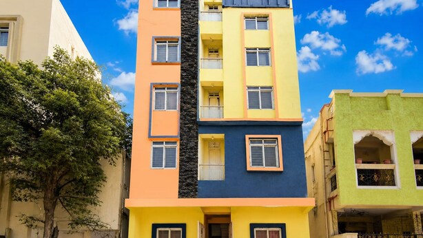 A multi-story building with balconies and windows, surrounded by trees. - Classic fo Sunidh (Hyderabad)