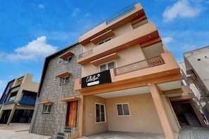 A multi-story building with a sign indicating 'Collection Company-Serviced.' - Collection O MKU Madurai (Madurai)