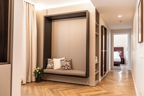 A modern room with a built-in seating area, wooden flooring, and a view into another room. - The Monkey Hotel  (Roma)