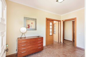 A hallway with a wooden dresser, a framed picture on the wall, and a door leading to another room. - Villa Jacinto - Three Bedroom Villa, Sleeps 6 (Albufeira)