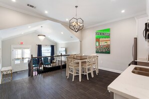 A modern kitchen with a built-in oven and a stainless steel refrigerator. - Vibrant NOLA Home for Large Groups (New Orleans)
