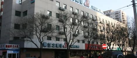 A multi-story building with signage for 'Jiang Inn' and 'Jiang Inn 2'.