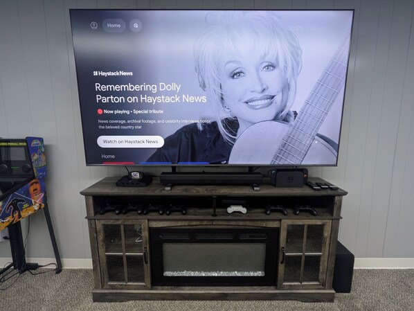 A television displaying a news program about Dolly Parton on Haystack News.