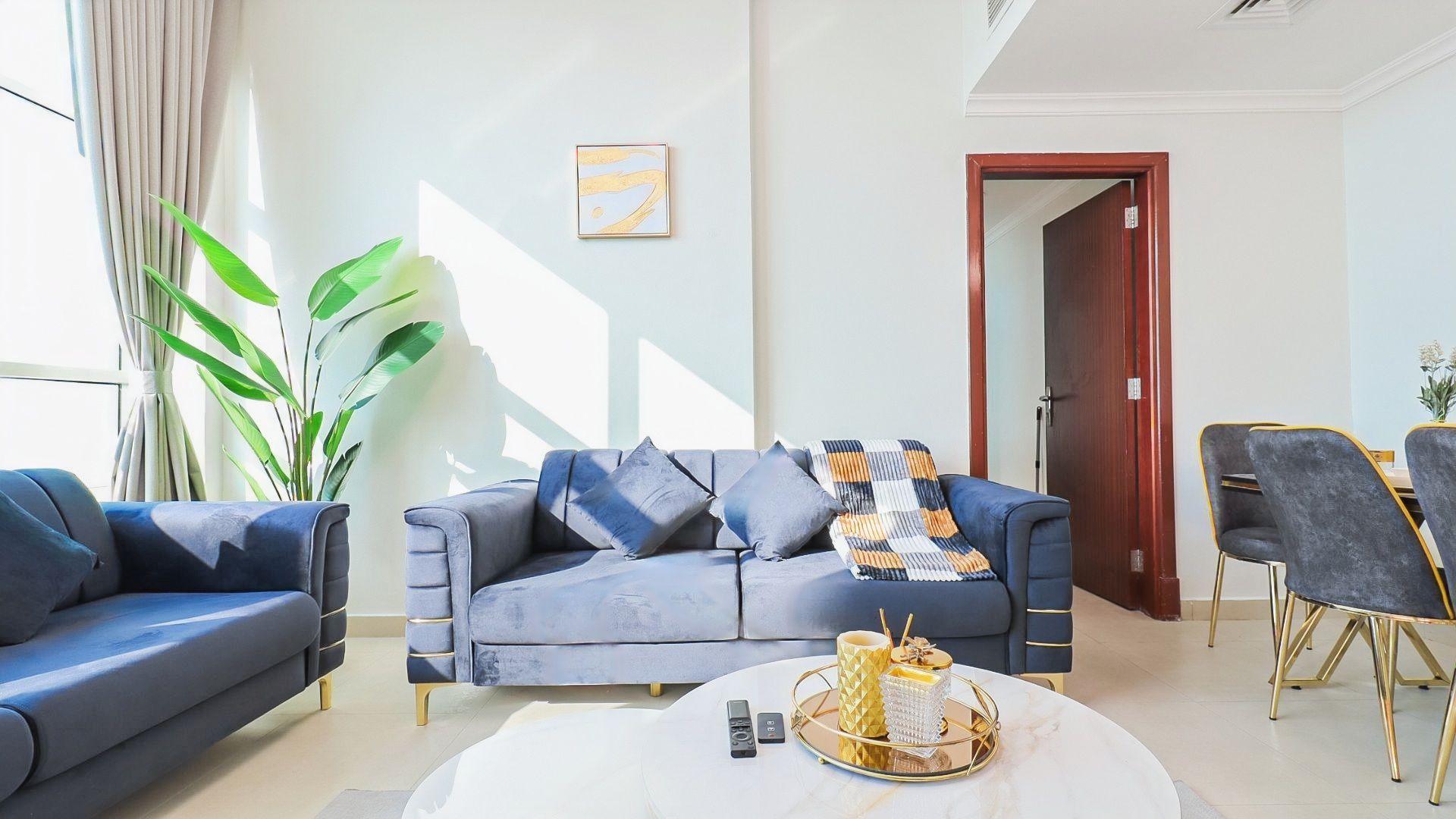 A modern living room with a sofa, coffee table, and chairs.