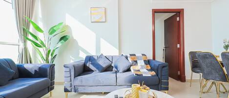 A modern living room with a sofa, coffee table, and chairs.
