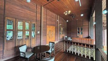 A wooden interior with a bar area, seating, and ceiling fans.