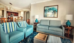 A living room with two sofas, a coffee table, and a painting on the wall. - Family friendly, Orlando fully equipped 2-bedroom condo over Christmas break. (Orlando)