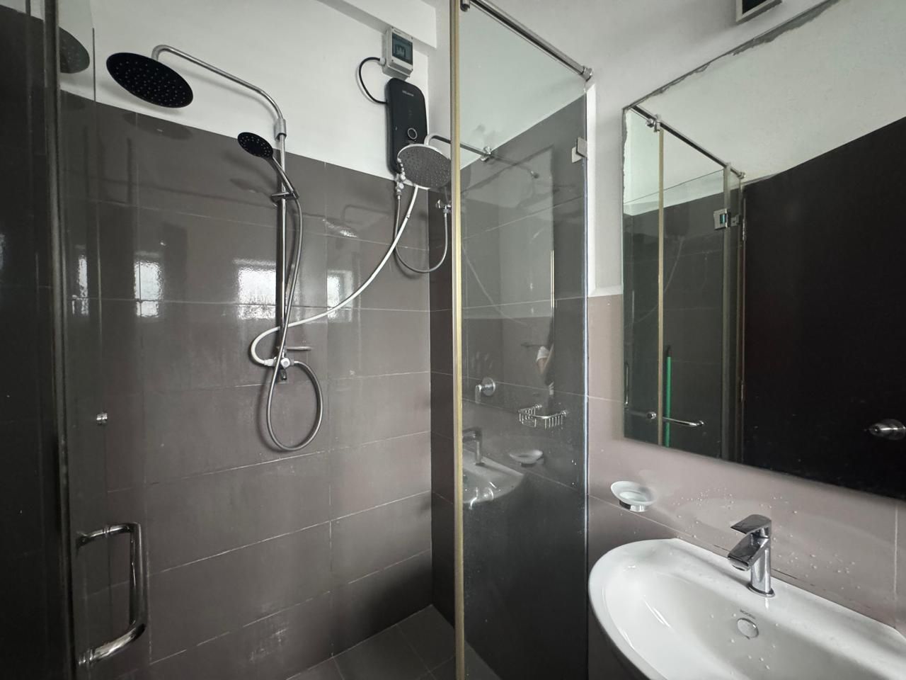 A modern bathroom with a glass shower enclosure, a sink, and a mirror.