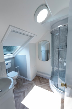 A modern bathroom with a shower, toilet, and sink. - The Stanley Arms Hotel by Guestz (Seascale)