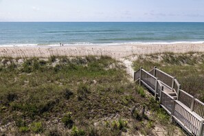 A beach with a wooden boardwalk leading to the shore. - Ocean Reef 8-A2 | Oceanfront Condo (Emerald Isle)