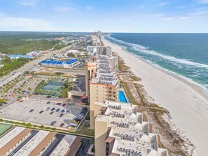 A coastal hotel with multiple buildings, a beach, and a parking lot. - 🌊 Beachfront Gulf Views | Indoor & Outdoor Pools | Phoenix V 116 (Orange Beach)