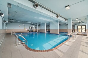 An indoor swimming pool with clear water, tiled walls, and metal railings. - 🌊 Beachfront Gulf Views | Indoor & Outdoor Pools | Phoenix V 116 (Orange Beach)