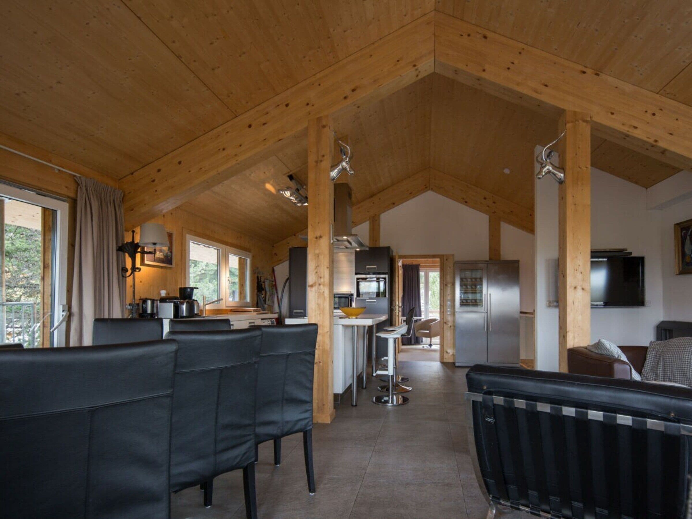 A modern interior with a kitchen, dining area, and seating space.