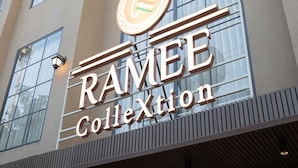 A building with a sign that reads 'RAMEE Collection.' - Classic With Twin Bed Checkin Amritsar (Amritsar)